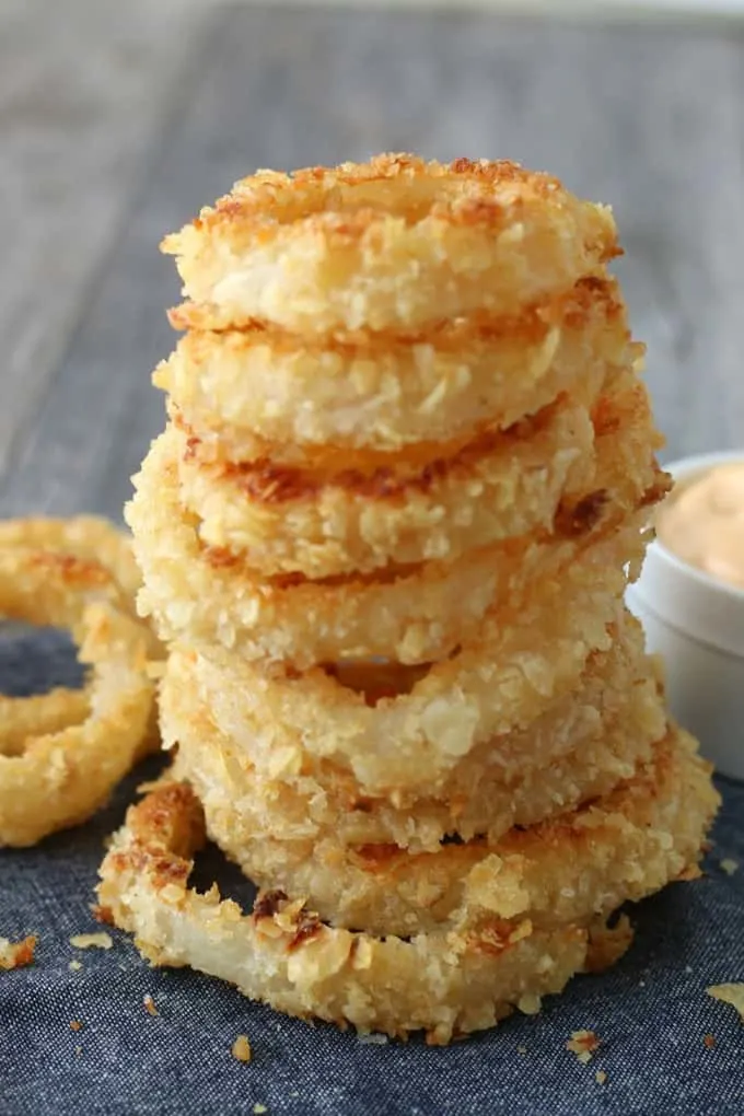 A stack of perfectly crunchy baked onion rings ready to be eaten. 