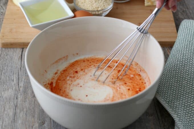 Whisking together the wet ingredients helps to make sure we end up with an even coating for crispy onion rings. 