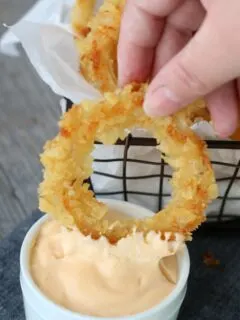 Onion ring dipped in aioli