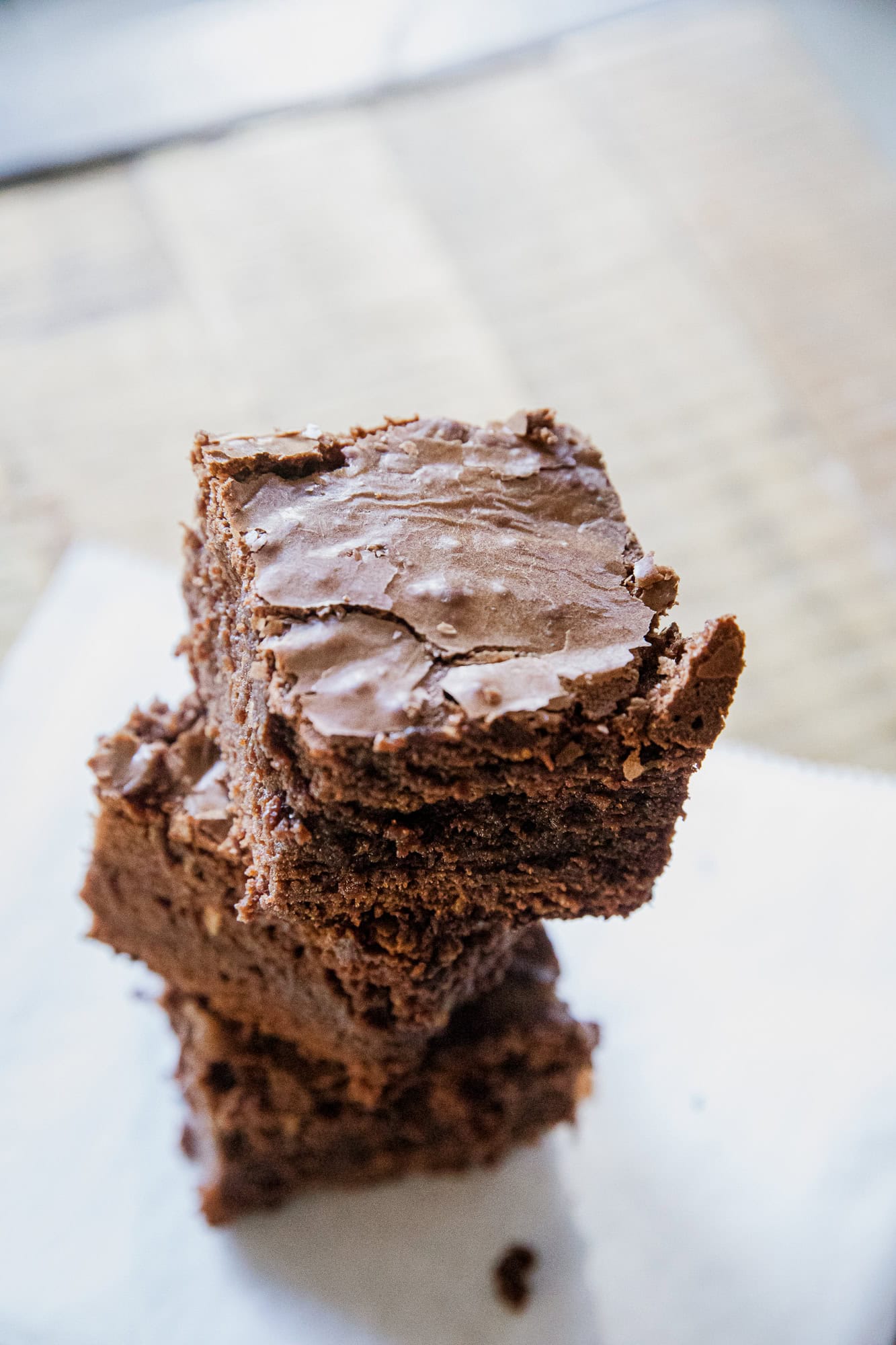 Close-up of stacked chocolate brownies with glossy frosting, perfect for dessert lovers.