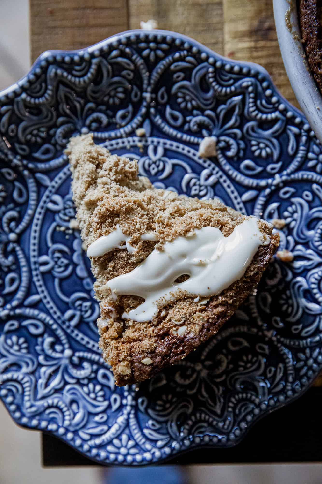 Delicious banana crumb cake with crunchy topping on a decorative blue plate. Perfect for breakfast o.