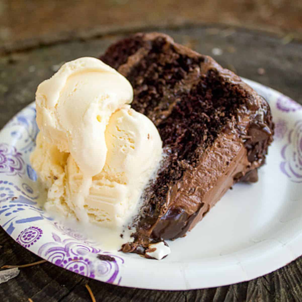 Chocolate quadruple birthday cake with ice cream.