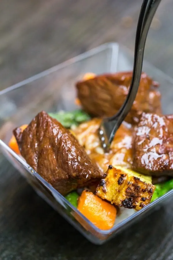 Steak bites are marinated in a soy-based sauce and quickly cooked. The marinade is then used as a sauce! YUM.