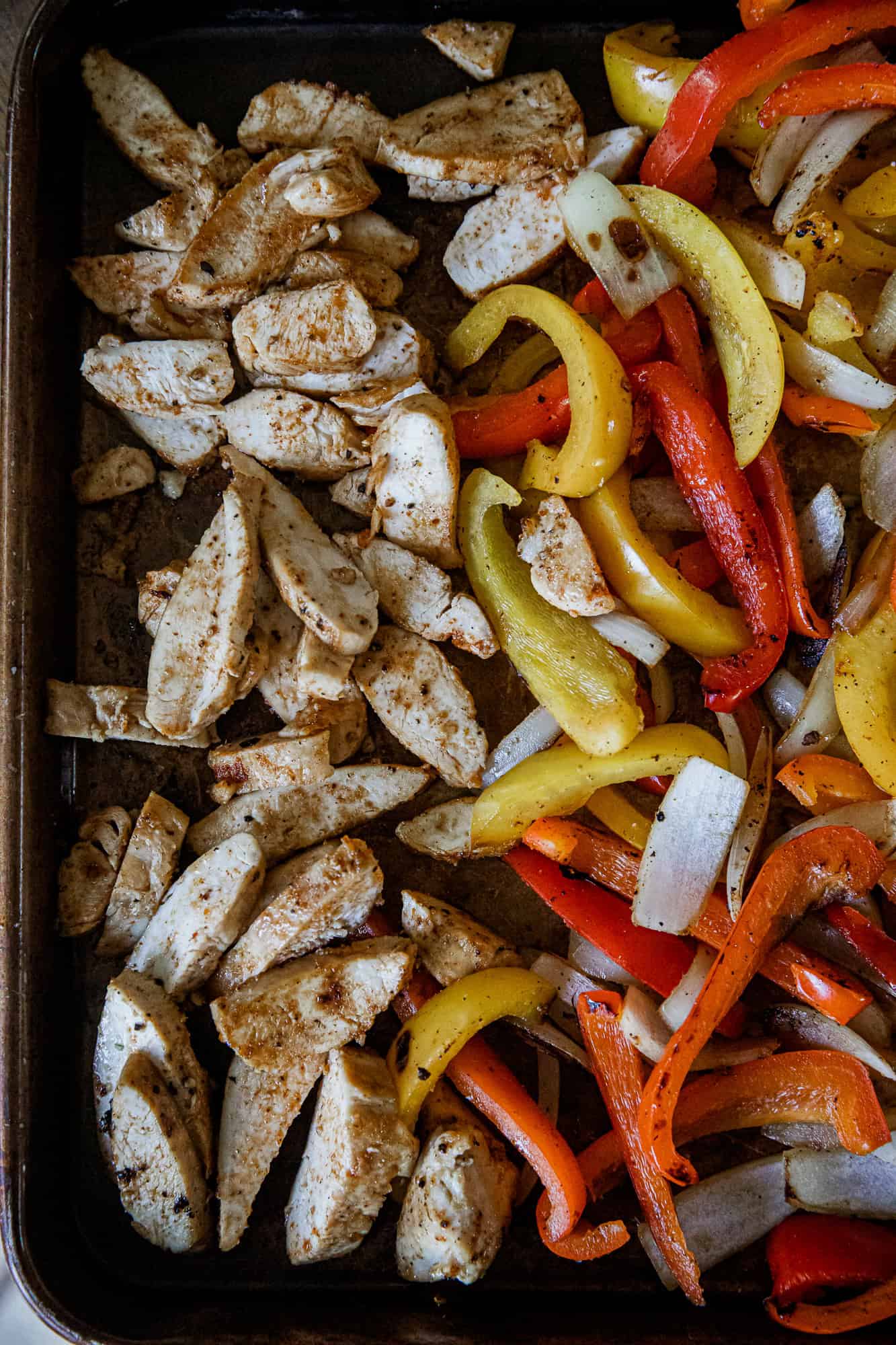 Cooked chicken and colorful bell peppers for easy chicken fajitas recipe.