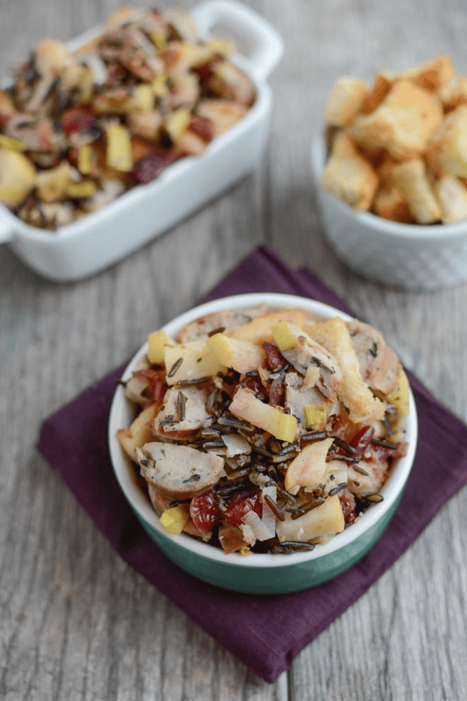 Colorful wild rice salad with vegetables and cheese in a bowl.