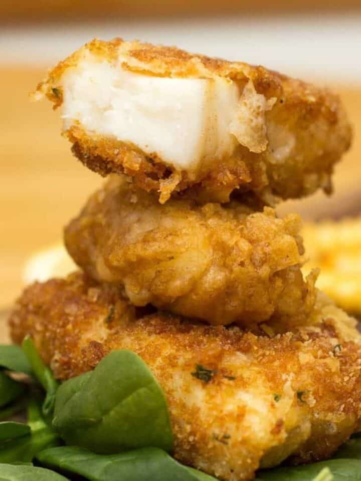 Crispy battered halibut fillet with a golden crust and tender white fish inside.