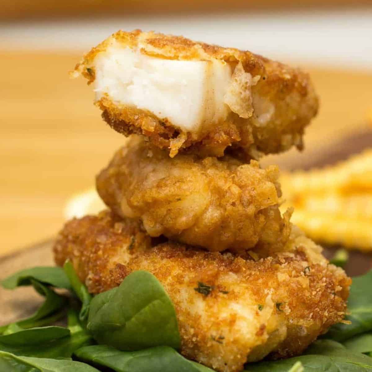 Crispy battered halibut fillet with a golden crust and tender white fish inside.