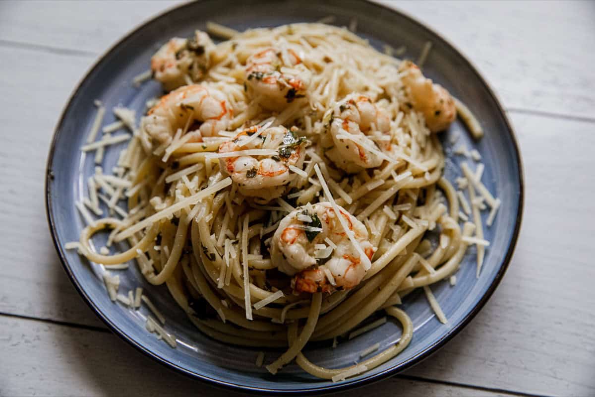 Delicious shrimp scampi pasta with grated cheese on top.