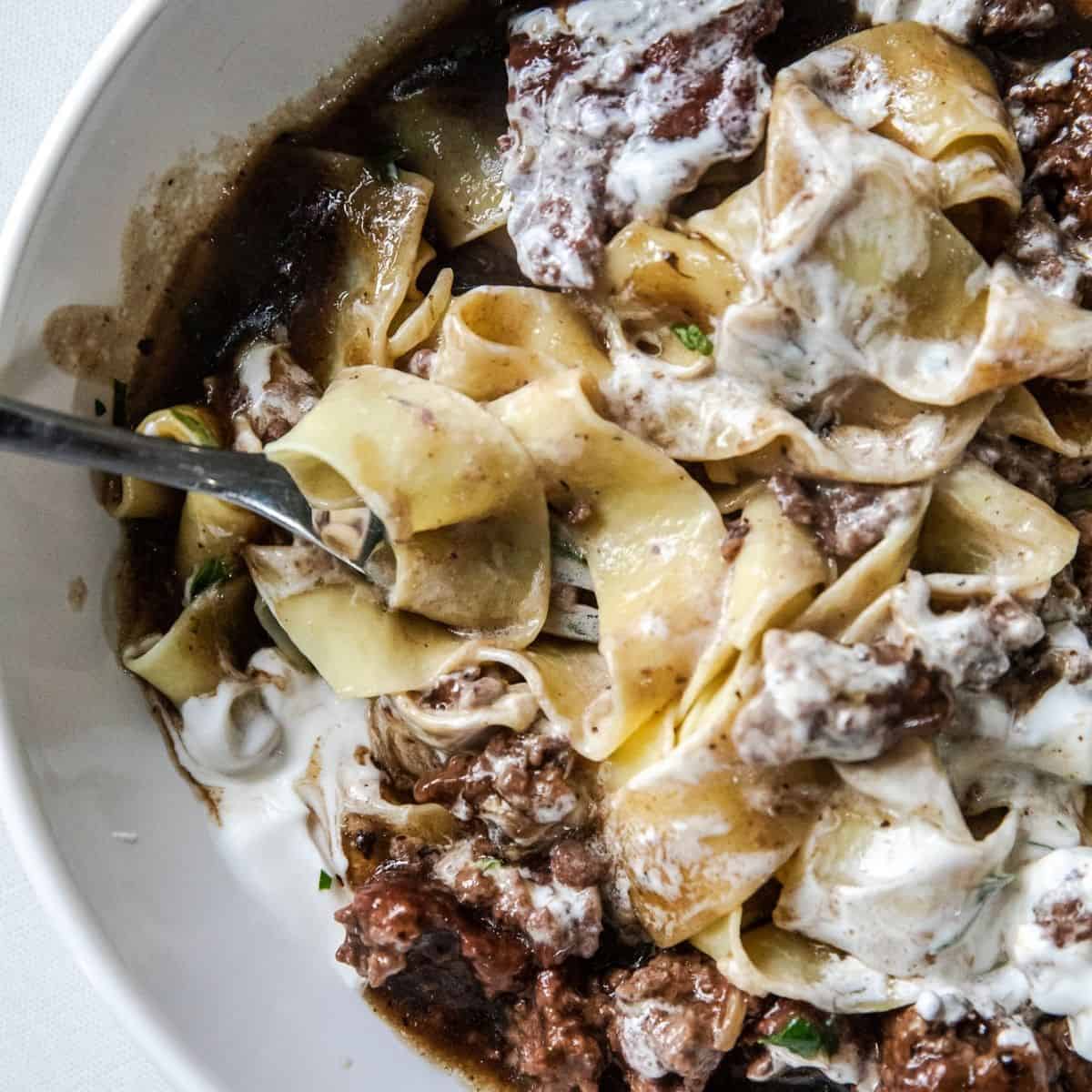 Close-up of creamy ground beef stroganoff with noodles and mushrooms.