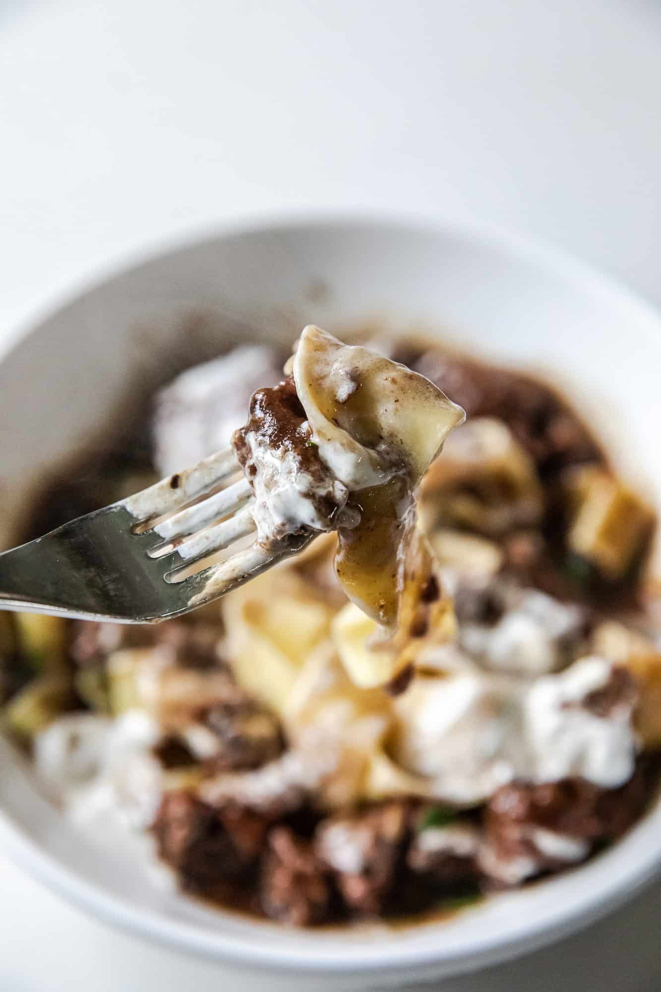 Close-up of creamy ground beef stroganoff on a fork.