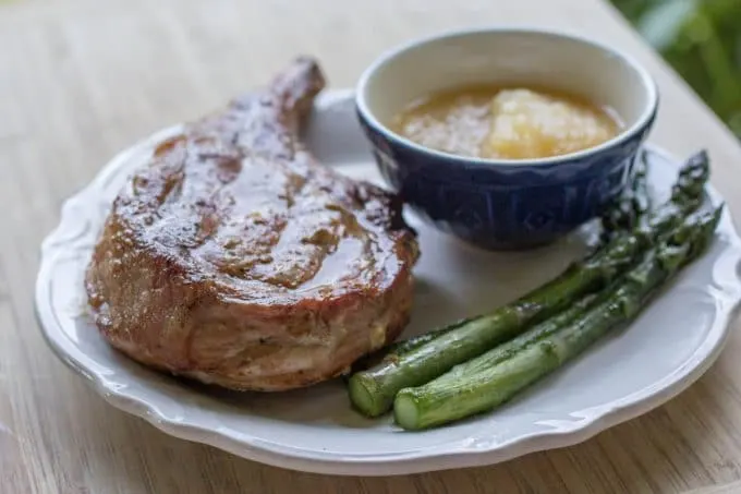 Traeger Grilled Pork Chops on white plate with vegetables