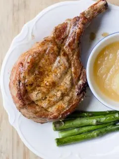 Traeger Grilled Pork Chops on a plate with asparagus