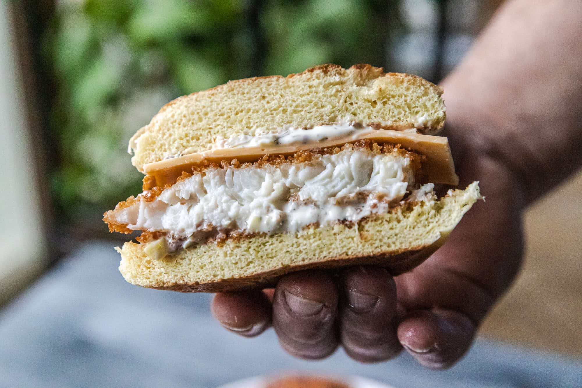 Delicious crispy panko fish sandwich with creamy sauce and fresh bread. Perfect for a flavorful lunc.