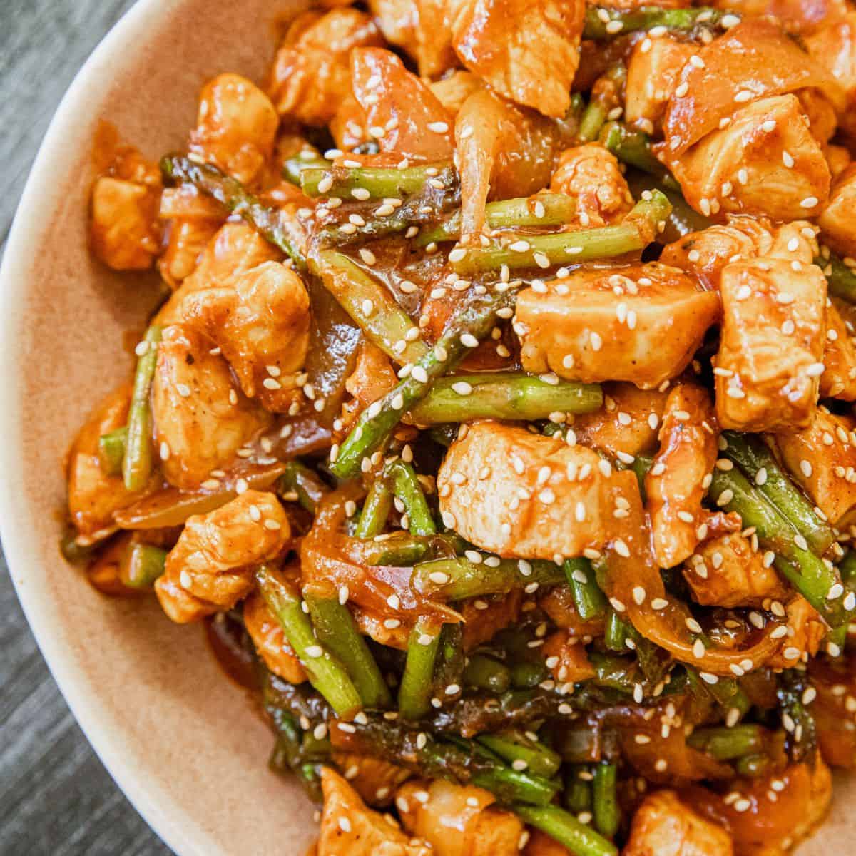 Delicious Gochujang Chicken Stir-Fry with green beans and sesame seeds.