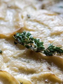 Traeger Scalloped Potatoes close up showing thyme on top