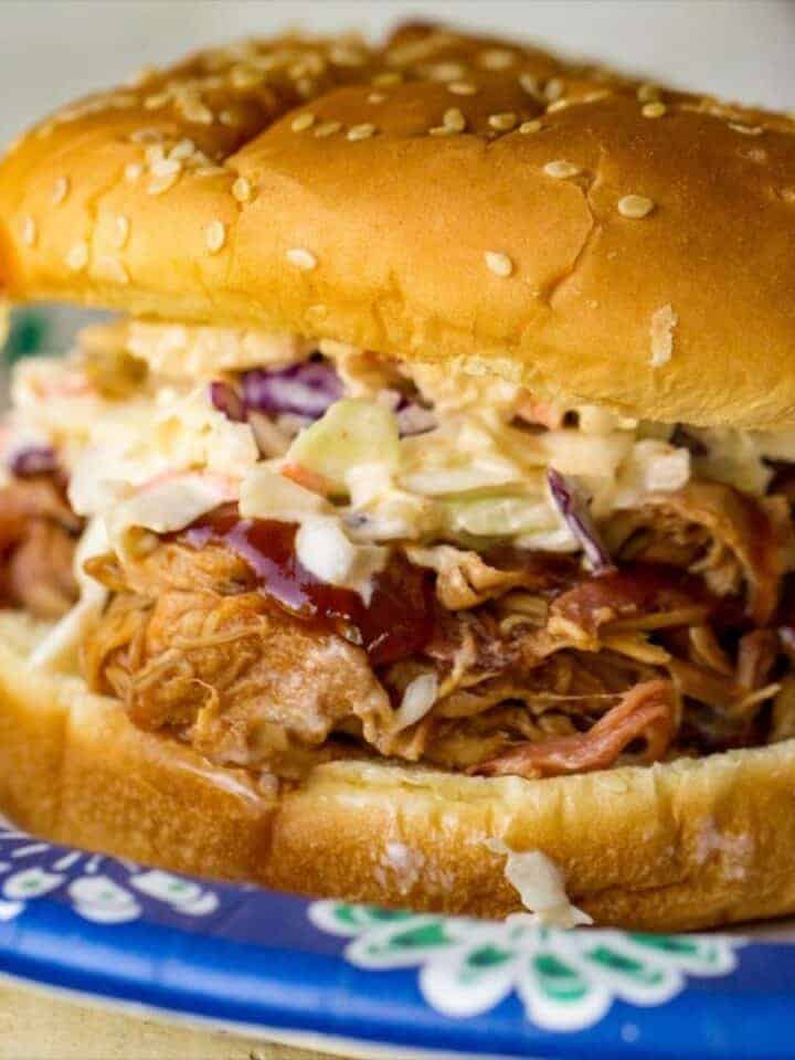 Pulled pork sandwich with coleslaw on sesame bun.