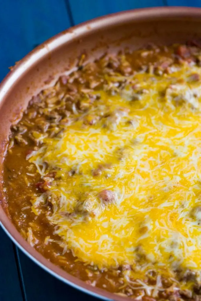beef and bean burrito skillet with melted cheese on top