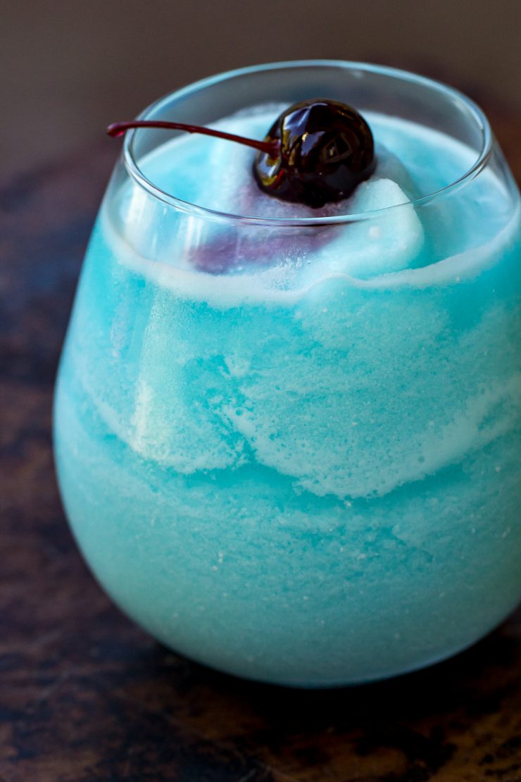 Blue Hawaiian Colada in a glass with a cherry on top