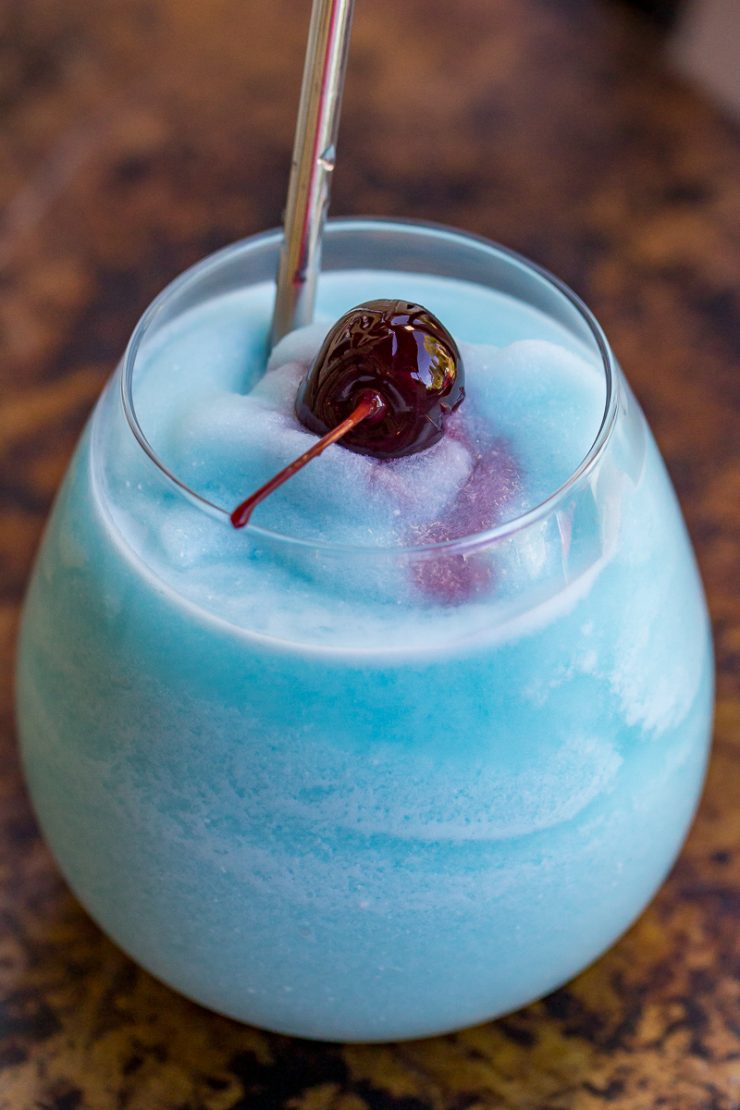Blue Hawaiian Colada with a straw and a cherry