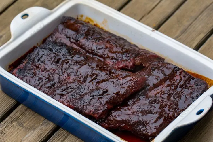 Ribs in a cast iron pan with sauce
