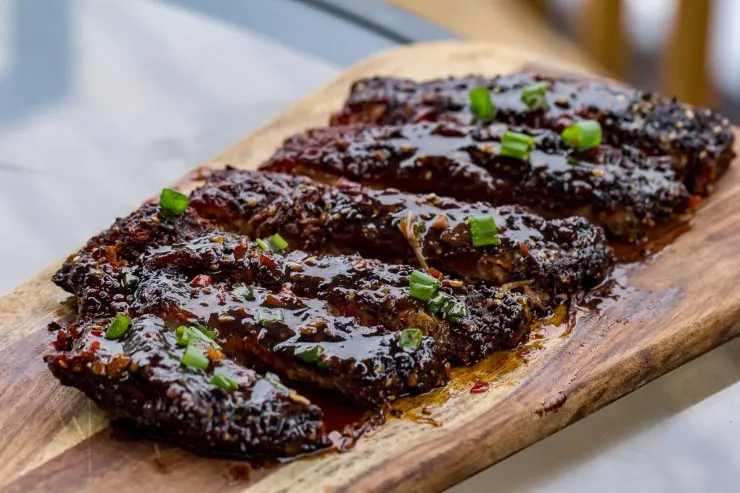 Spicy Asian Pork Ribs on a wooden cutting board