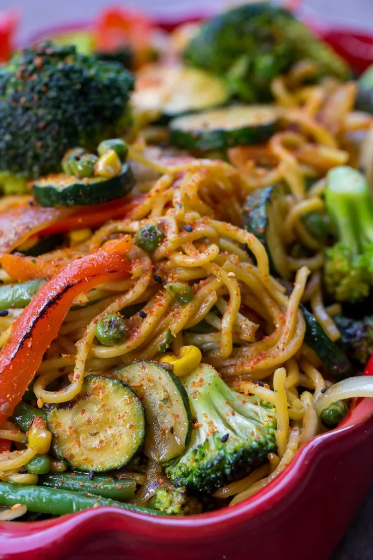 Vegetable Yakisoba close up with lots of broccoli, zucchini, and red bell pepper slices