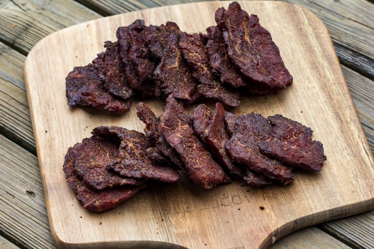 beef jerky on a wood cutting board