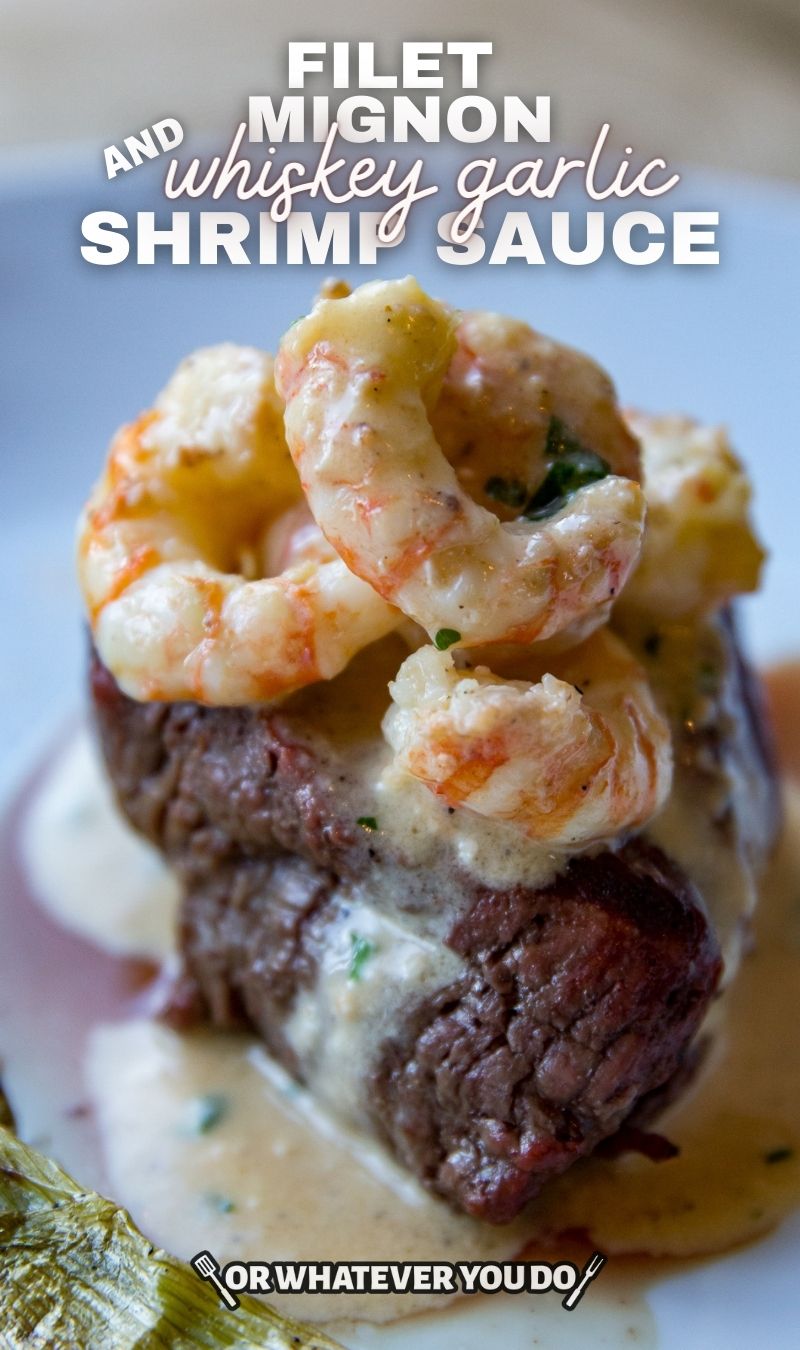 steak on a plate with shrimp and creamy sauce poured over the top