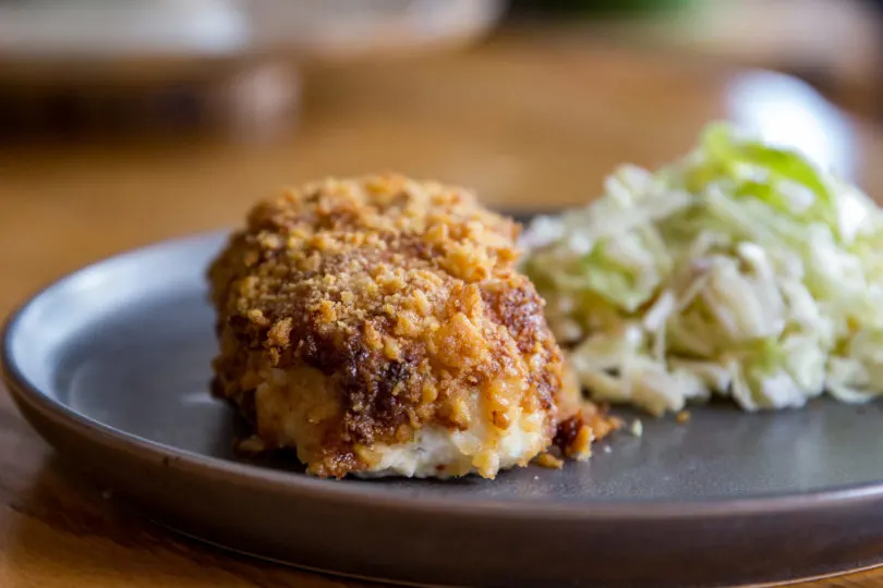 Air Fryer Parmesan Crusted Halibut on a plate with coleslaw