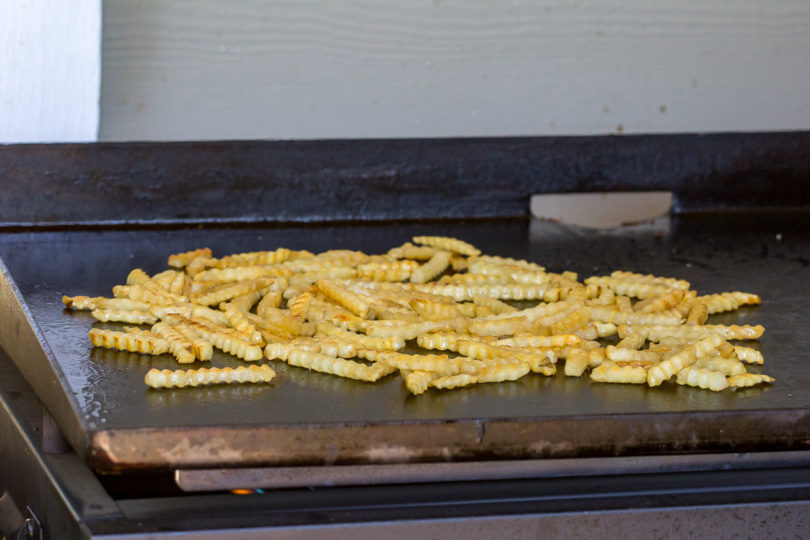 french fries cooking on a Blackstone Gas Griddle