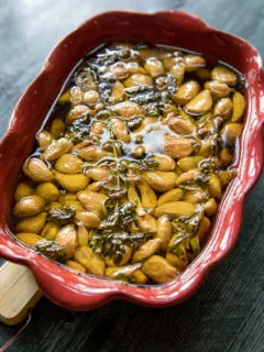 Smoked Confit Garlic in a red baking dish