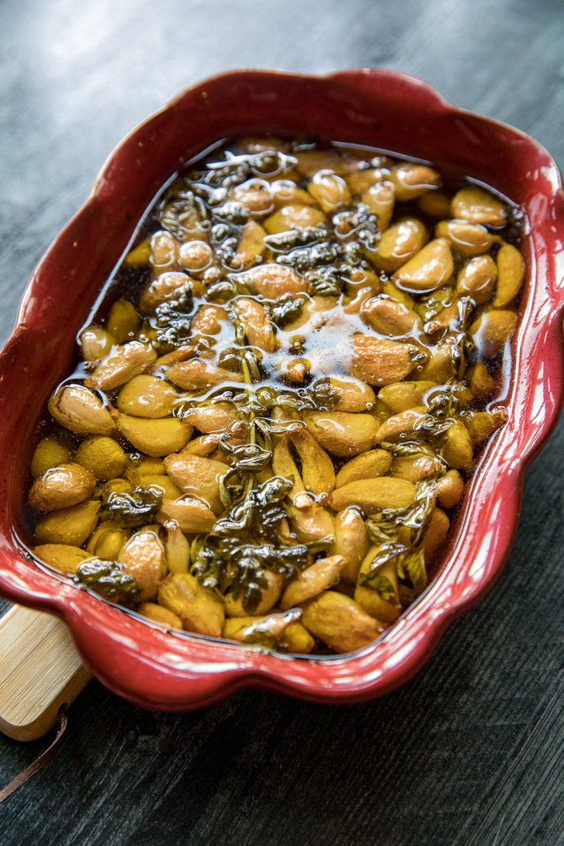 Smoked Confit Garlic in a red baking dish