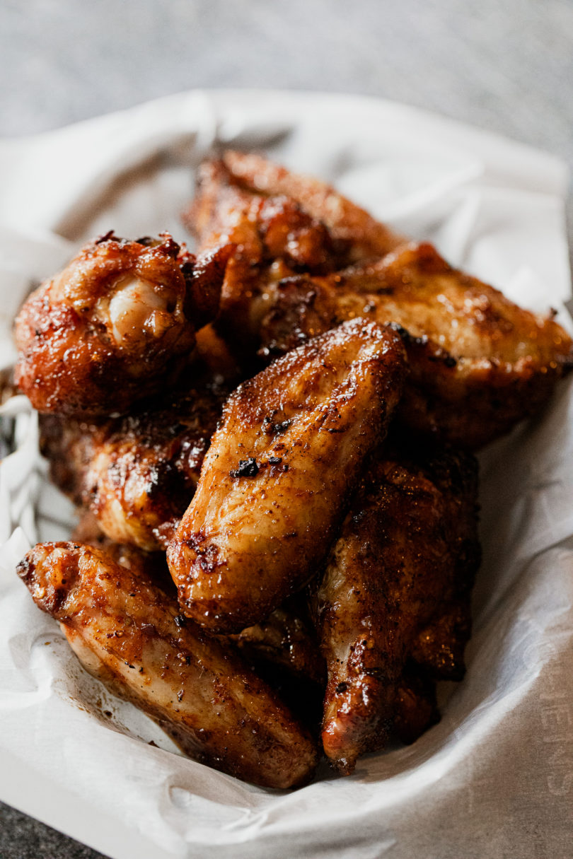 Sweet Heat Smoked Chicken Wings in a basket on parchment paper