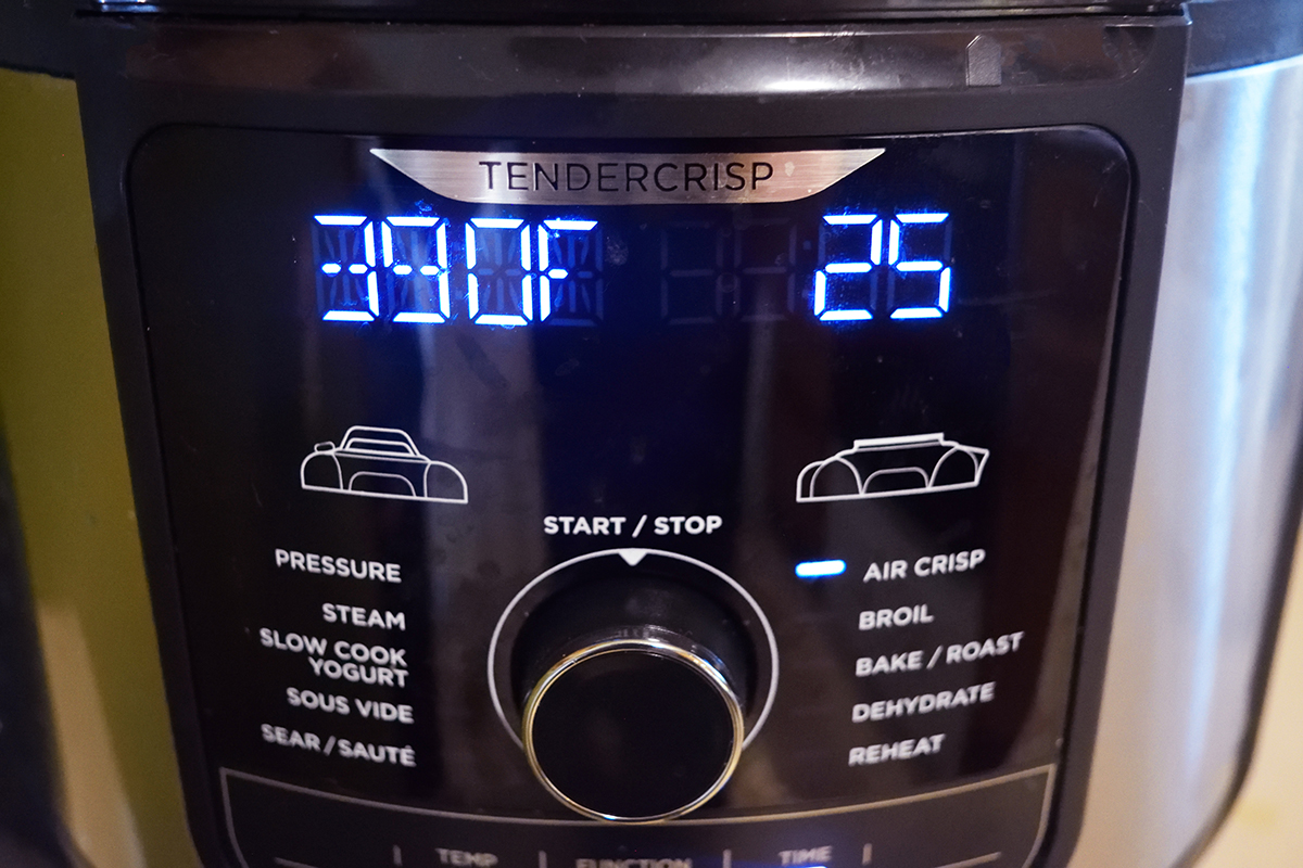 An air fryer with a digital display on it.