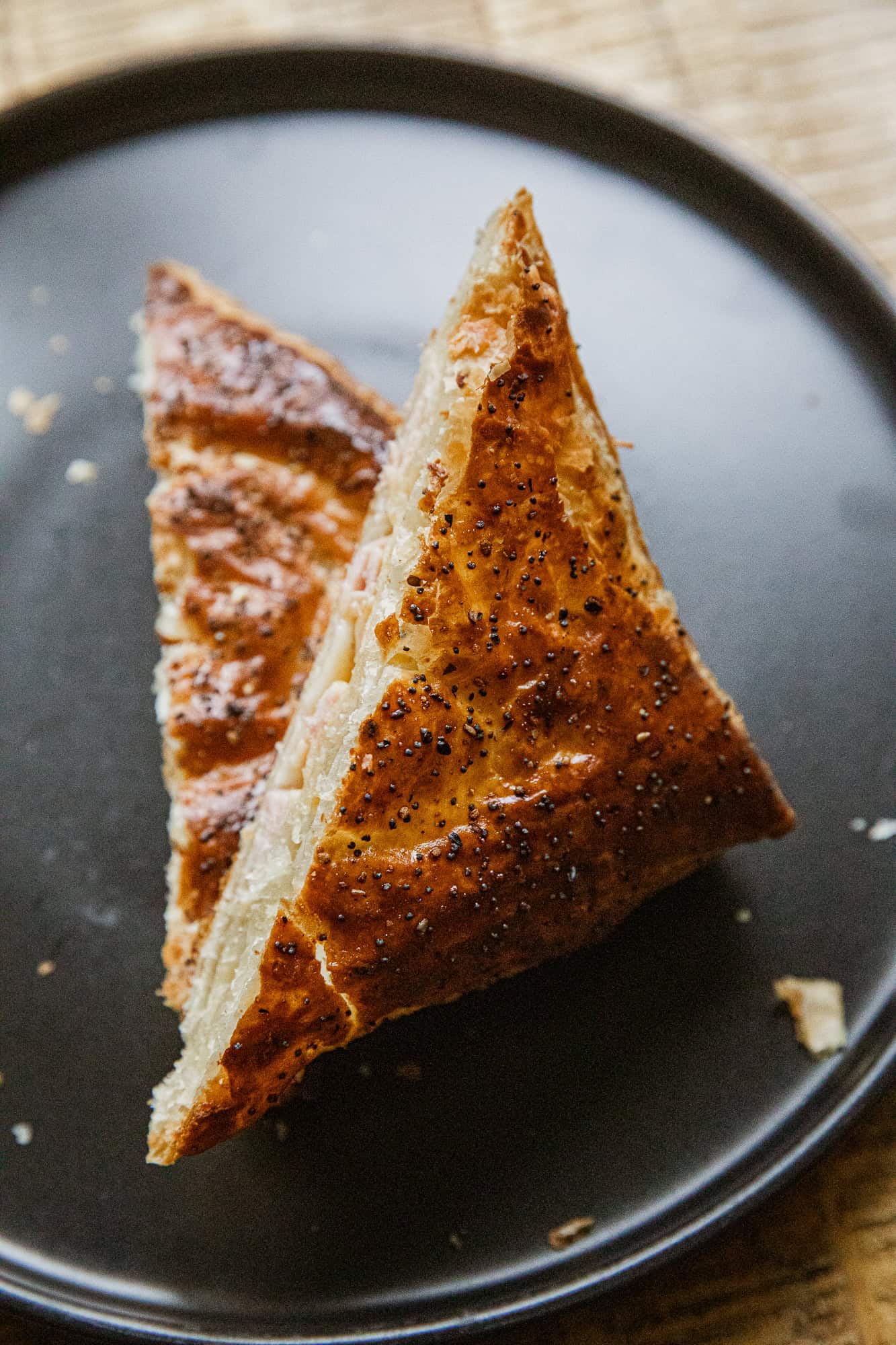 Ham and cheese hot pockets on a black plate, perfect for grilling.