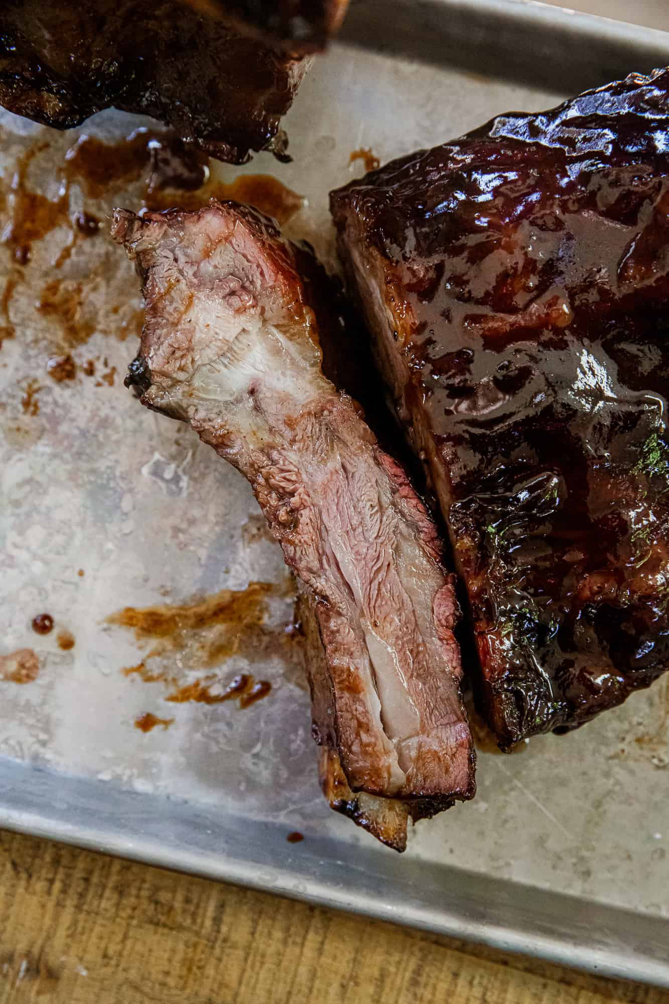 Smoked prime rib bones with juicy, tender meat and rich smoky flavor, perfect for hearty meals or fl.