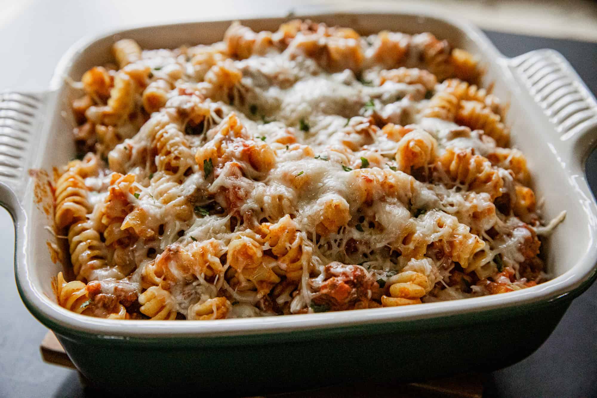 Baked cheesy rotini pasta casserole with melted cheese and herbs.