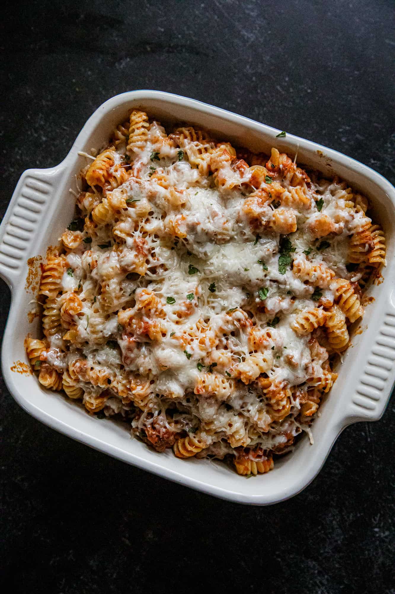 Delicious cheesy rotini pasta bake topped with melted cheese, perfect for comfort food lovers.