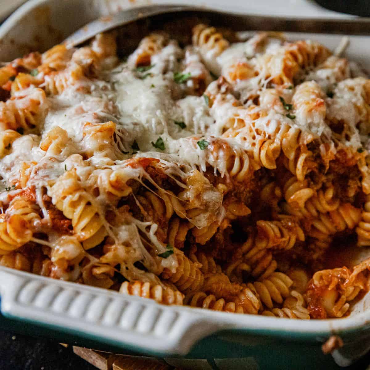 Delicious cheesy rotini pasta bake with melted cheese and savory sauce, perfect for a comforting mea.