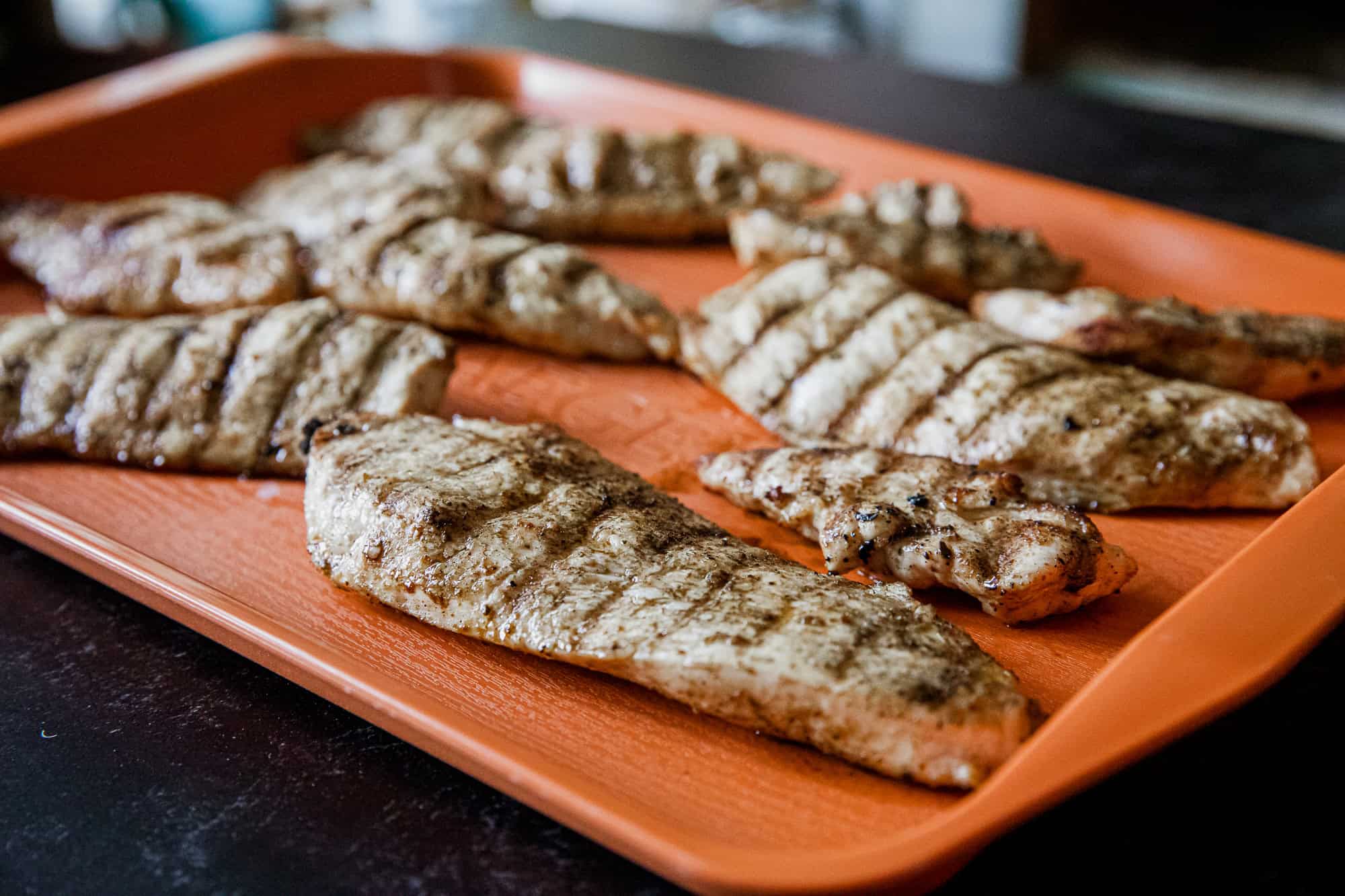 Juicy grilled chicken breasts with perfect grill marks on a Traeger grill. Ideal for healthy, flavor.