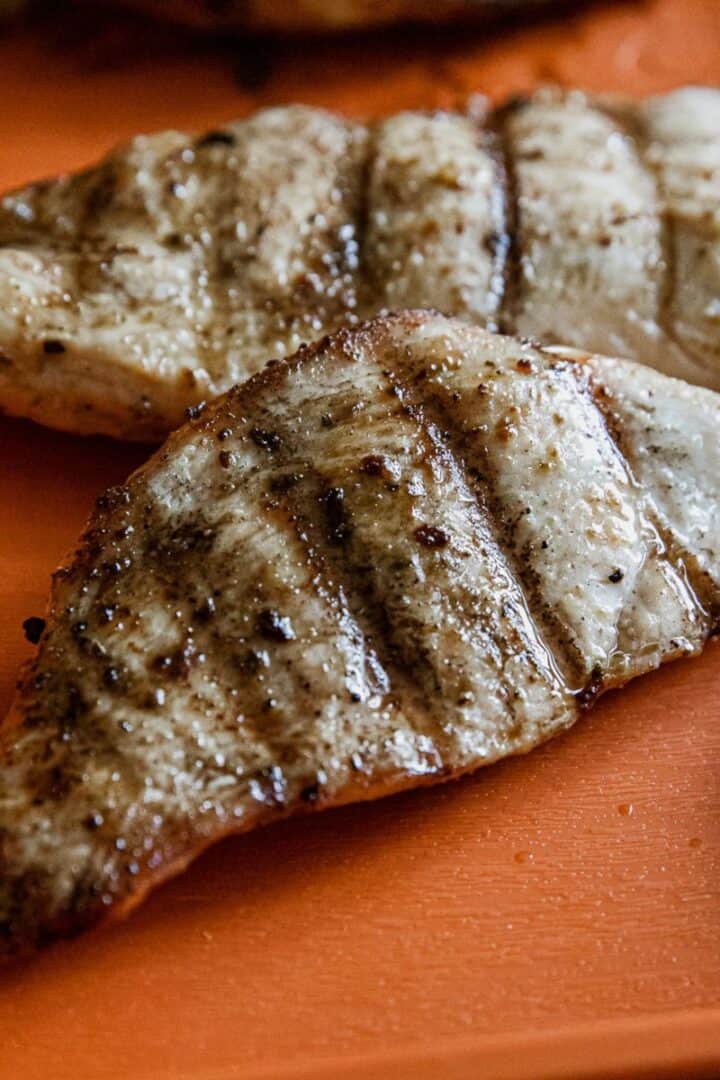 Juicy Traeger-grilled chicken breasts with grill marks and seasoning.