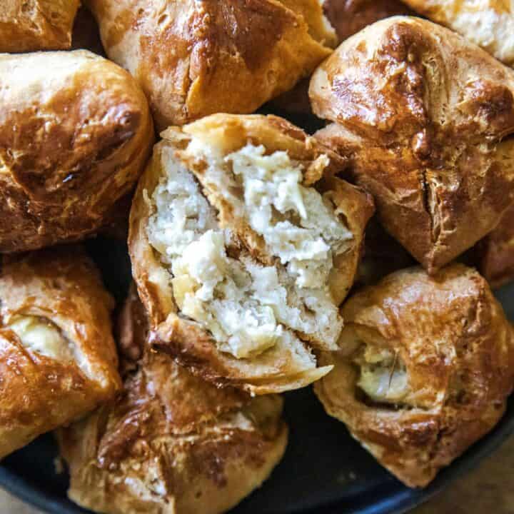 Delicious bite-sized biscuit bites filled with creamy artichoke dip, perfect for appetizers or snack.