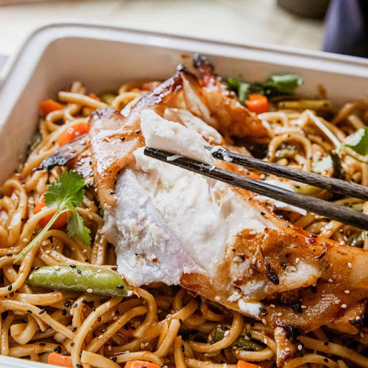 Stir-fried noodles with chicken, vegetables, and herbs in a savory sauce.