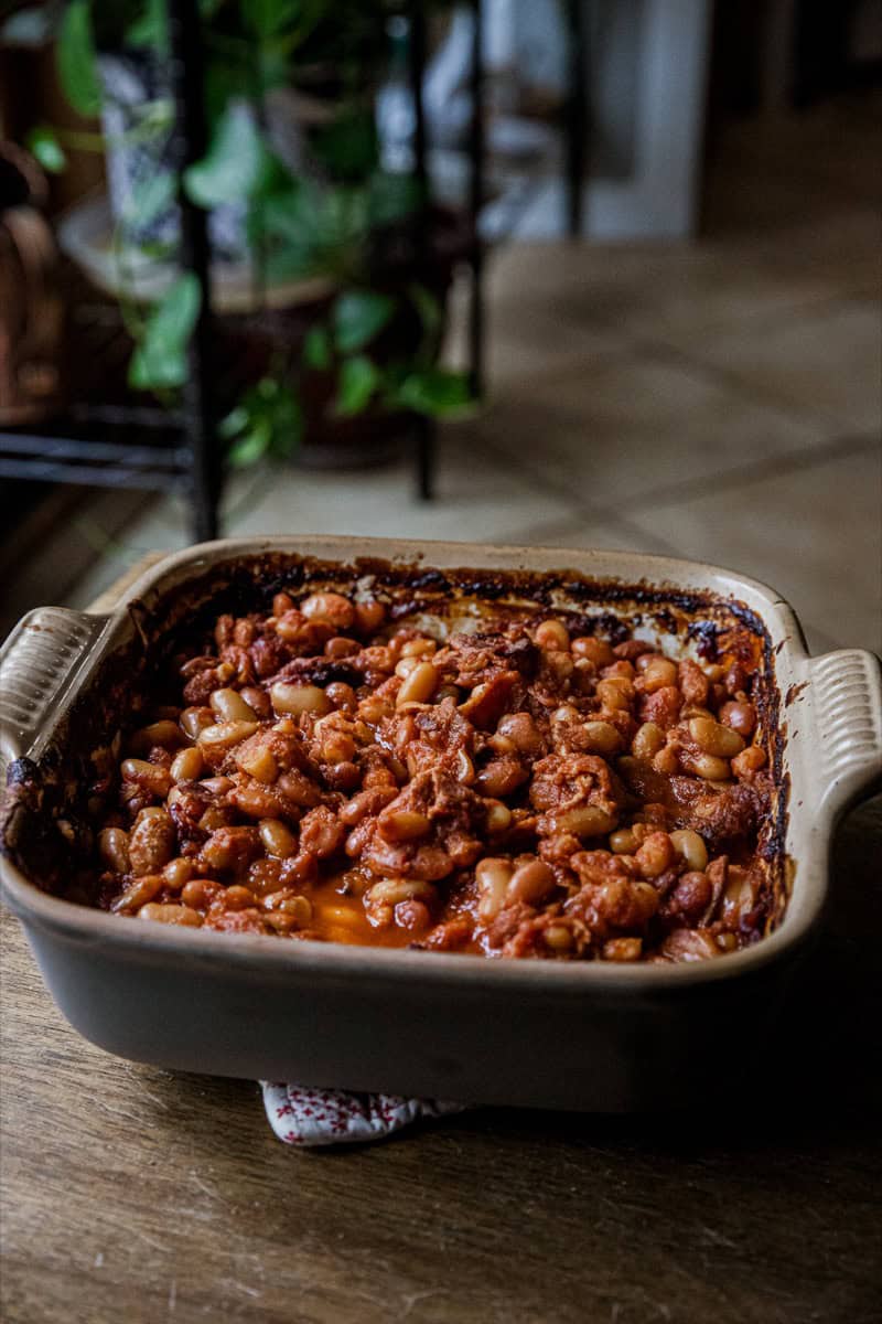 Delicious baked bean casserole in a ceramic dish, ready to serve.