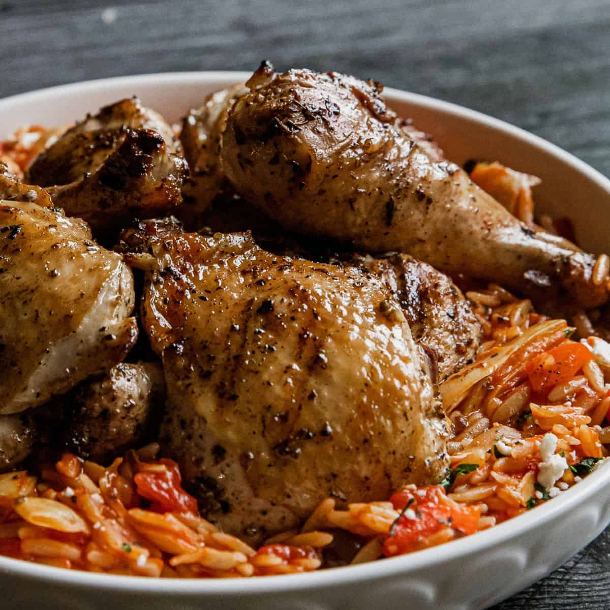 Juicy roasted chicken thighs served with flavorful tomato basil rice.
