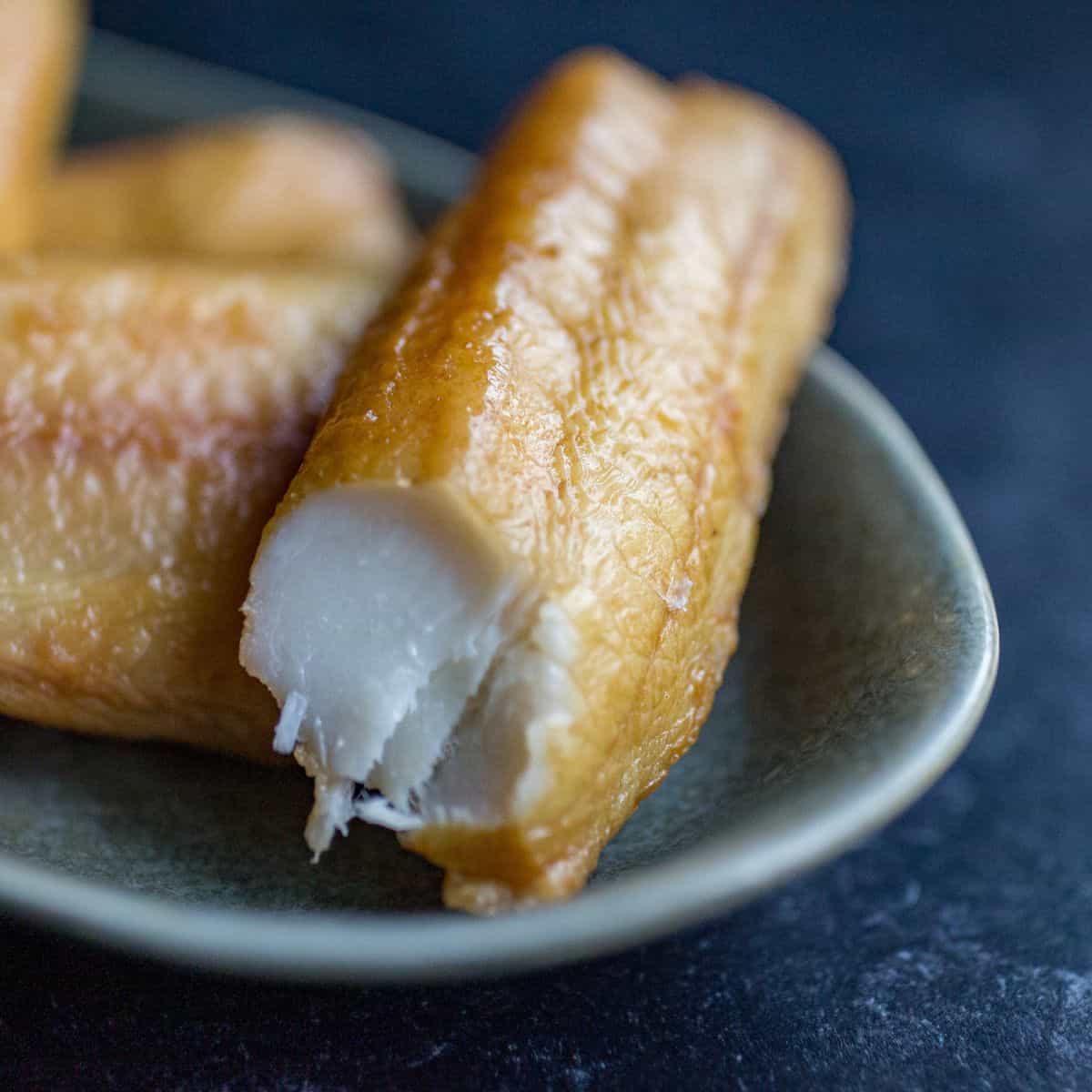 Delicious cheese-filled fried snack served on a ceramic plate, perfect for a savory treat or appetiz.