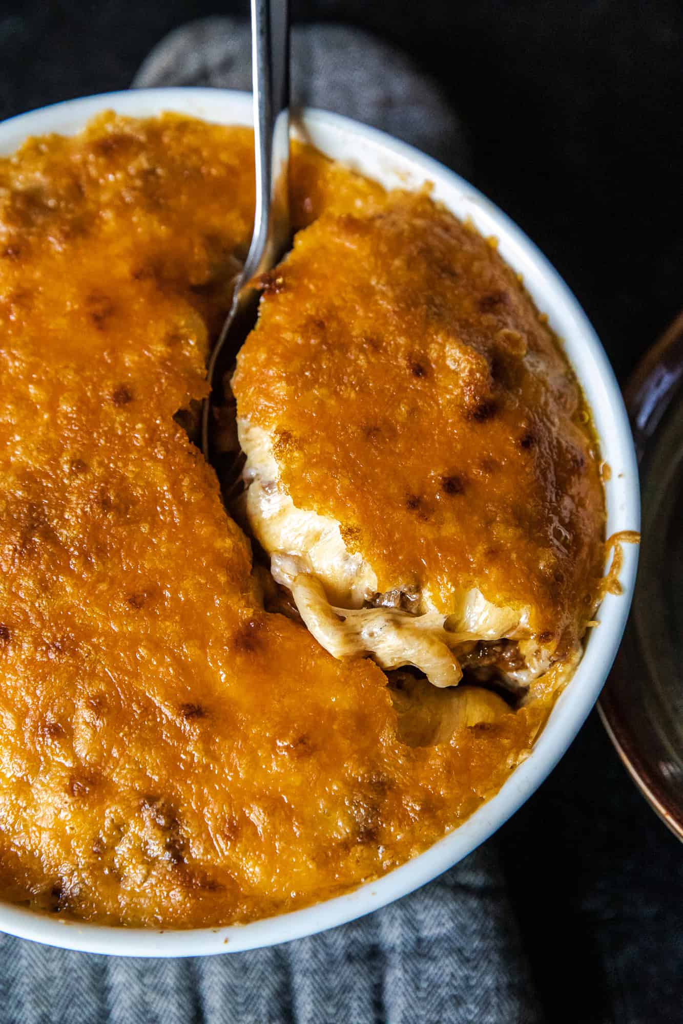 Baked chili mac casserole with golden cheese crust and creamy filling.