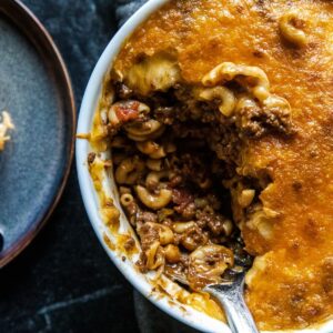 Close-up of a baked chili mac casserole with cheese and pasta.