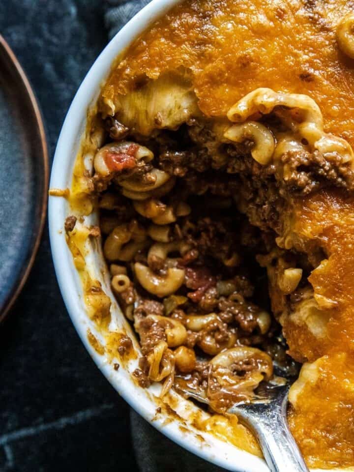 Close-up of a baked chili mac casserole with cheese and pasta.