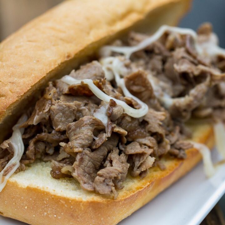 Blackstone Philly cheesesteak sandwich with melted cheese.